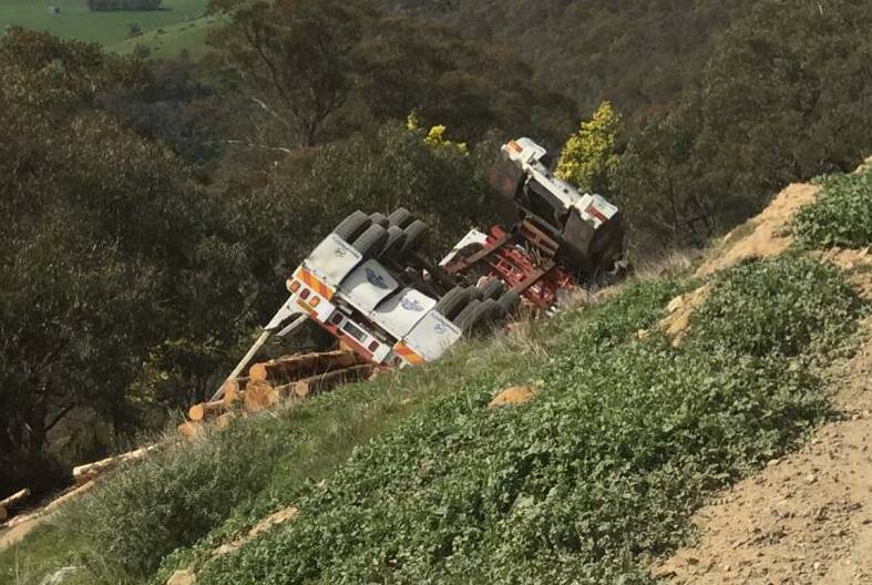 ROLLED: The truck came to rest on the side of the road in a Tallangatta Valley pine plantation. 