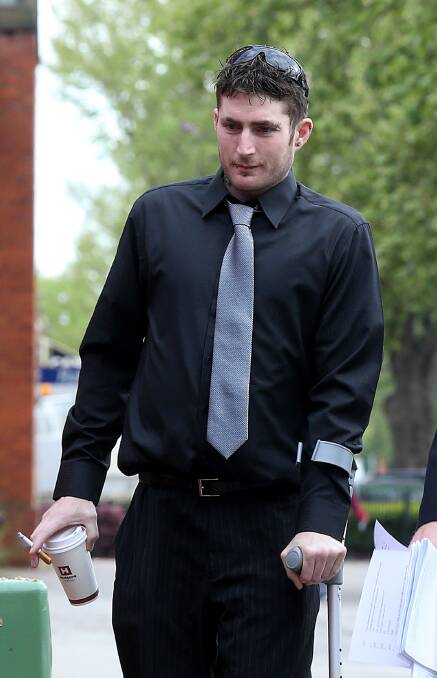 ON CRUTCHES: Matthew Freund outside Albury court in 2012, during the committal for a man accused of shooting him. 