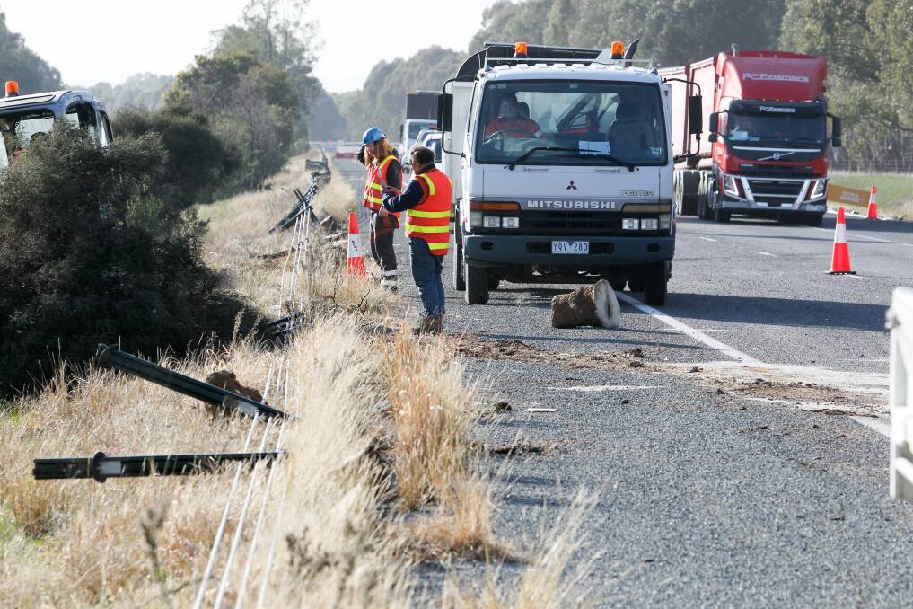 COLLISION: Roadworkers check the damage to wire rope barriers on the Hume Highway at Wangaratta in July following a collision with a truck. Picture: BLAIR THOMSON