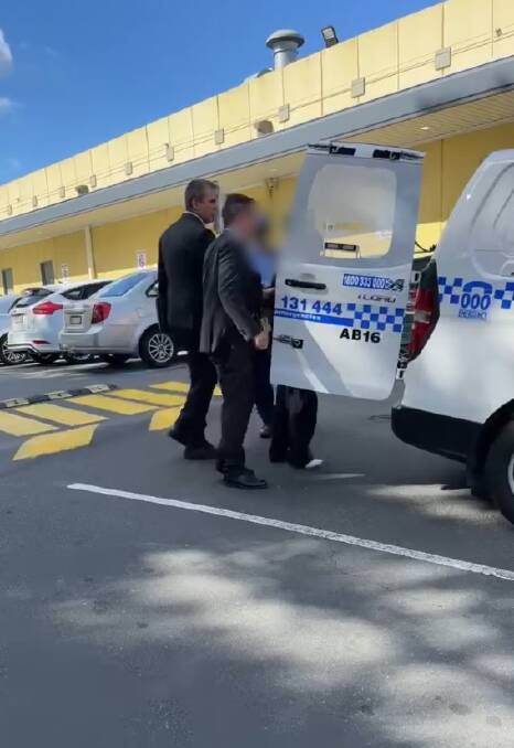 ARREST: The man is taken into custody outside the West End Plaza in Albury on Monday. 