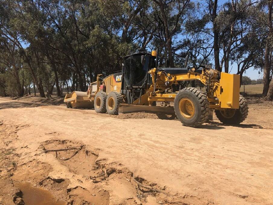FIX: A grader being used to repair a damaged road. 