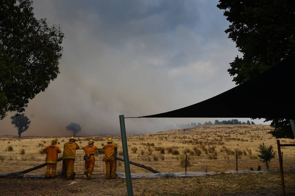 BURNING: Firefighters wait for the fire to come towards Indigo Valley Primary School on December 20, 2015. 