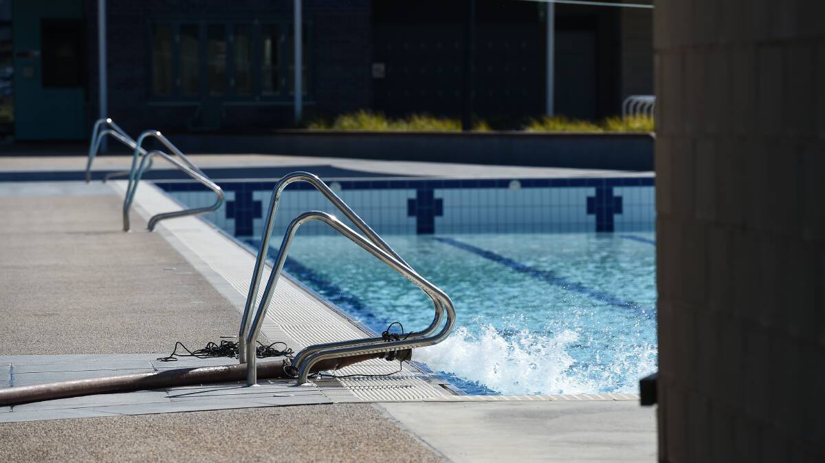 FILLING UP: A hose is used to add water to the fixed WAVES pool in Wodonga on Friday. The pool appears to be close to full capacity. Picture: MARK JESSER