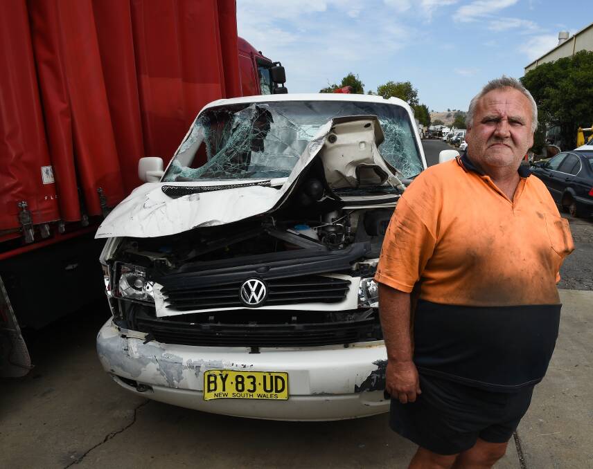 FRUSTRATED: Jetis Car and Truck wreckers manager Clive Williams with a vehicle used to ram through the front of the Fallon Street business in the early hours of Sunday. Picture: MARK JESSER