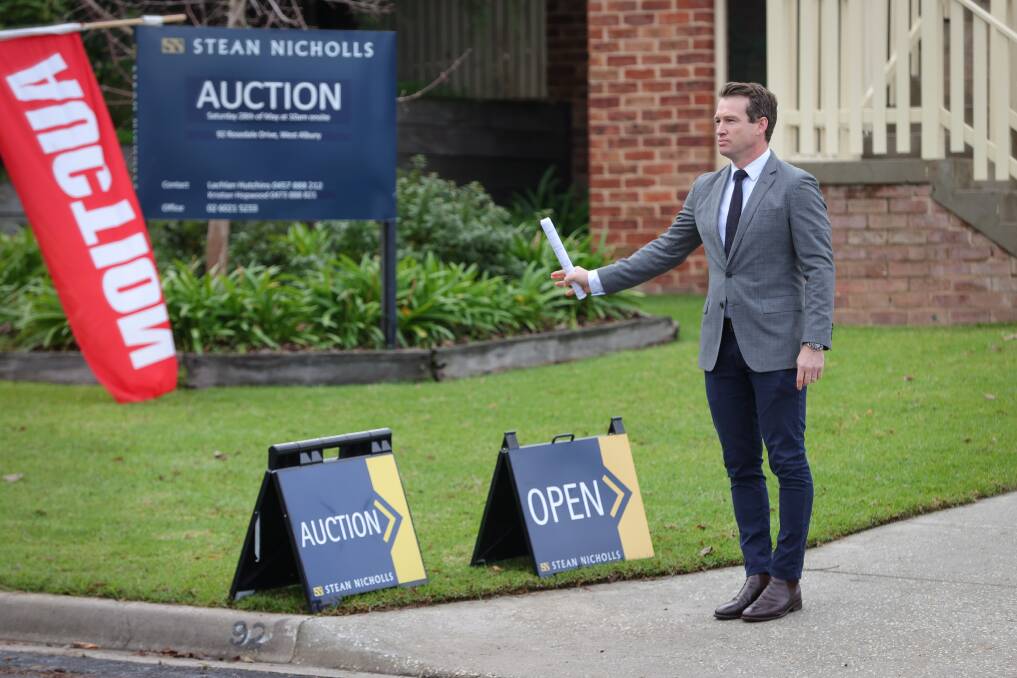 PASSED IN: Auctioneer Lachlan Hutchins at a home on Rosedale Drive in West Albury, which was passed in on Saturday. Multiple other homes sold at auction on the Border on Saturday. Picture: JAMES WILTSHIRE