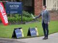PASSED IN: Auctioneer Lachlan Hutchins at a home on Rosedale Drive in West Albury, which was passed in on Saturday. Multiple other homes sold at auction on the Border on Saturday. Picture: JAMES WILTSHIRE