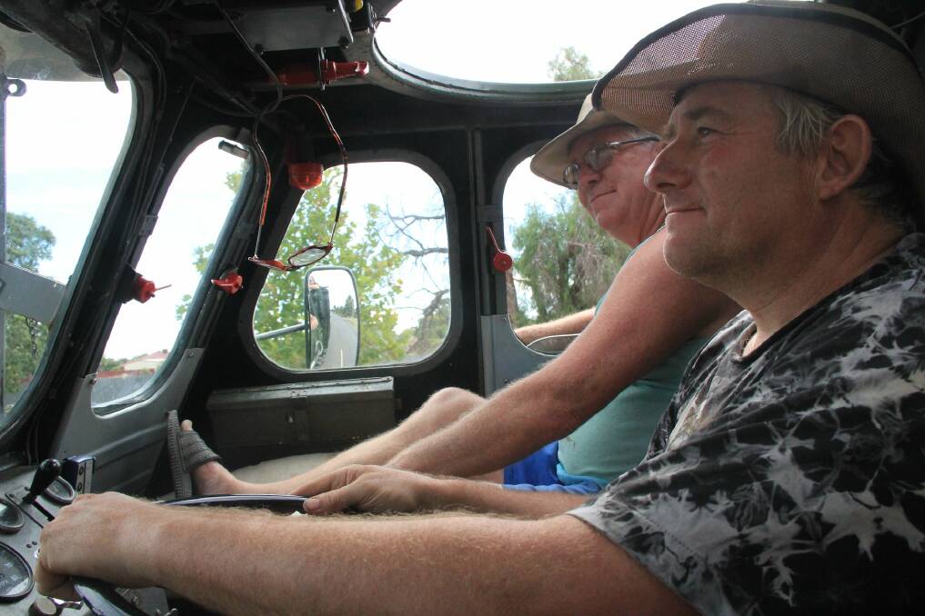 DRIVING: Graham Arkle, pictured right, in his amphibious vehicle. 