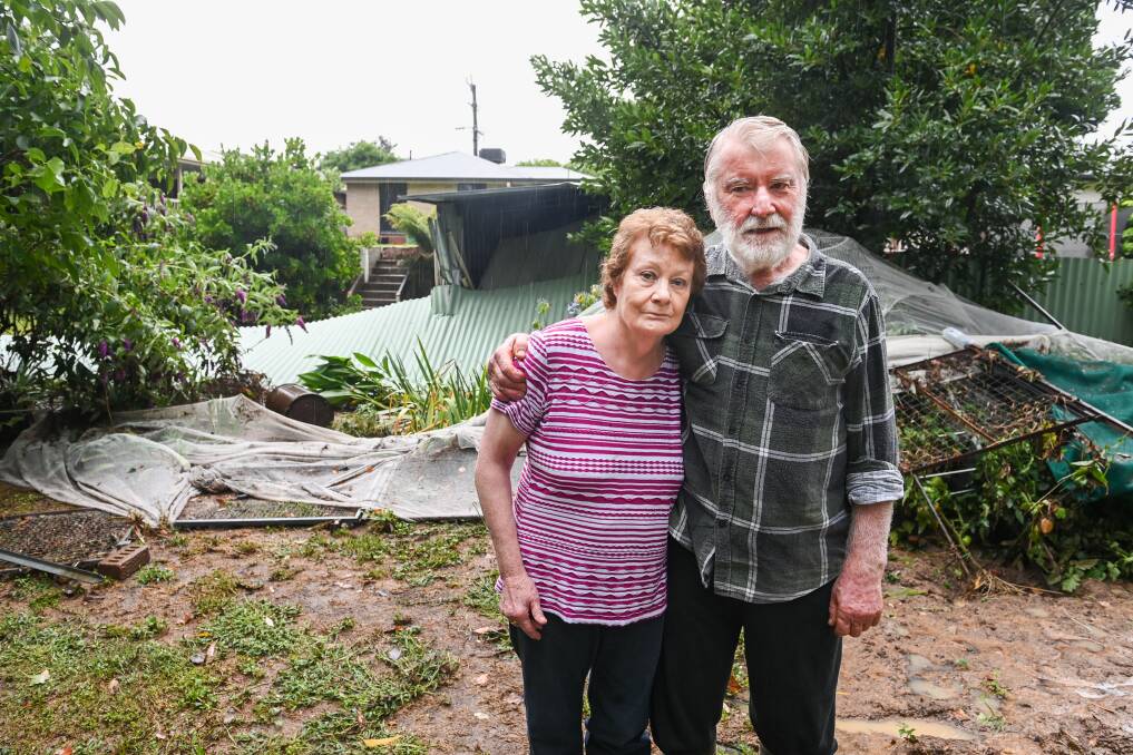HIGH WATERS: Diane and Philip McCabe at the back of their Lavington property following damaging flooding. The water knocked over fences, flooded sheds and washed away gardens. Picture: MARK JESSER