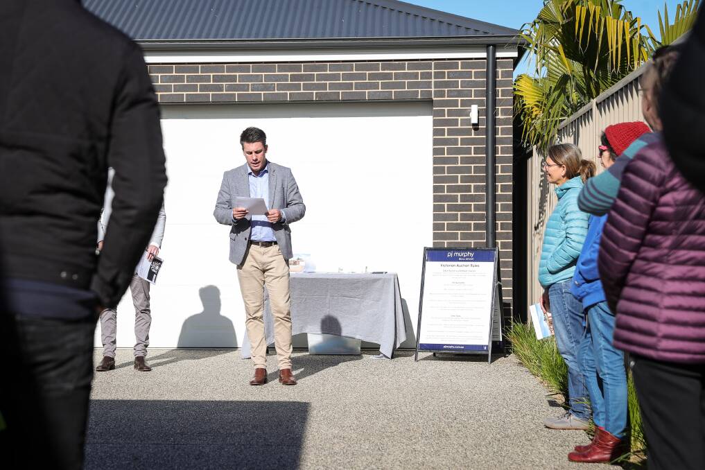 PASSED IN: PJ Murphy agent Leon Kowski with a townhouse on Stanley Street in Wodonga on Saturday. The property failed to attract a bidder and was passed in at $640,000 following a vendor bid. Picture: JAMES WILTSHIRE