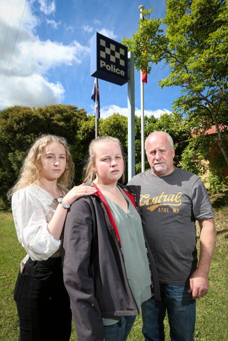 HARD TO COMPREHEND: Rhiannon Symons, supported by her sister Hollie and father Darryl, can't understand why her pet was killed. Picture: JAMES WILTSHIRE