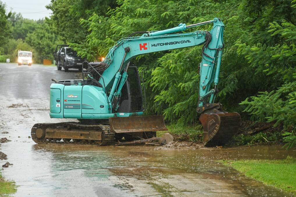 EXCAVATOR: Machinery was brought in on Friday morning to clear debris on the Roach Street bridge. 