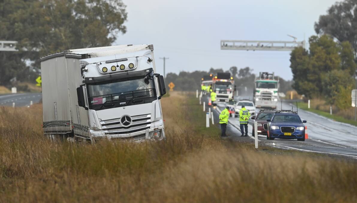 OFFLINE: The white Mercedes Benz truck became stuck on the side of the Hume Highway at Table Top on Tuesday, in an almost identical spot to an ambulance that slid and rolled on Saturday. Picture: MARK JESSER