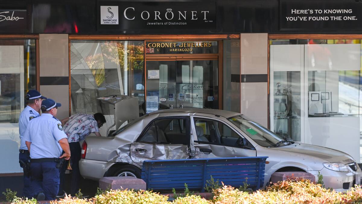 CRASH: A probationary driver's silver Mazda rolled back into the Coronet Jewellers building at the intersection of Dean and Olive streets on Saturday following a crash with another car. The other vehicle only sustained minor damage. Picture: MARK JESSER