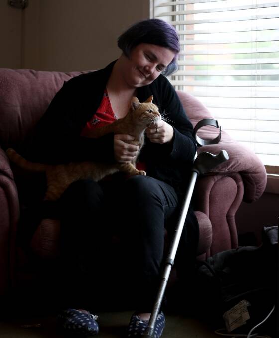 STUCK: Olivia Beaufort at home with her cat, Lily. The theft of her mobility scooter has left her struggling to get around. Picture: JAMES WILTSHIRE