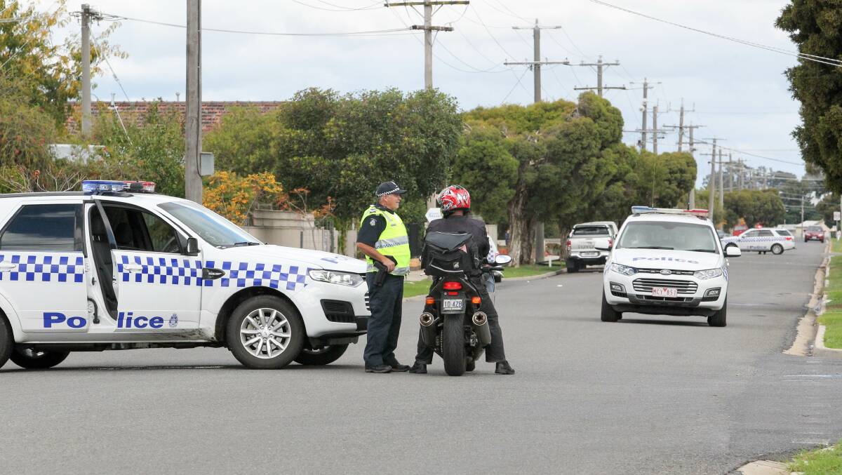 ROAD BLOCK: Police shut roads surrounding the property amid fears Mr Floyd was armed inside. 