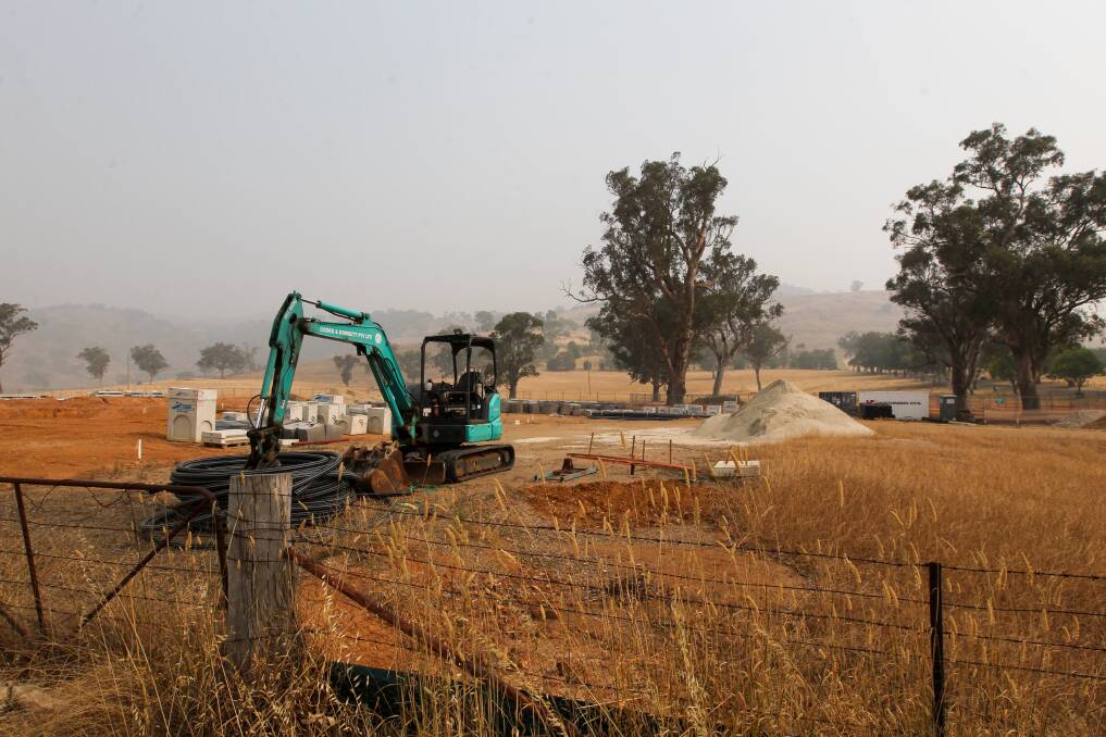 DELAYS: An excavator, precast concrete and piping is visible at the Tallangatta development, which is yet to get off the ground after a large amount of rock was found underground at the Murray Valley Highway site. 