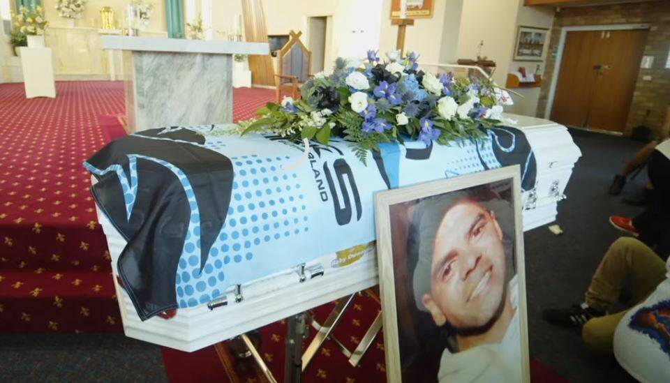 CASKET: Mr Johnson's coffin was draped with a Cronulla Sharks flag. 