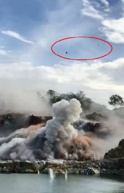 EXPLOSION: A still image from a video of the incident, with the flying rock circled. 