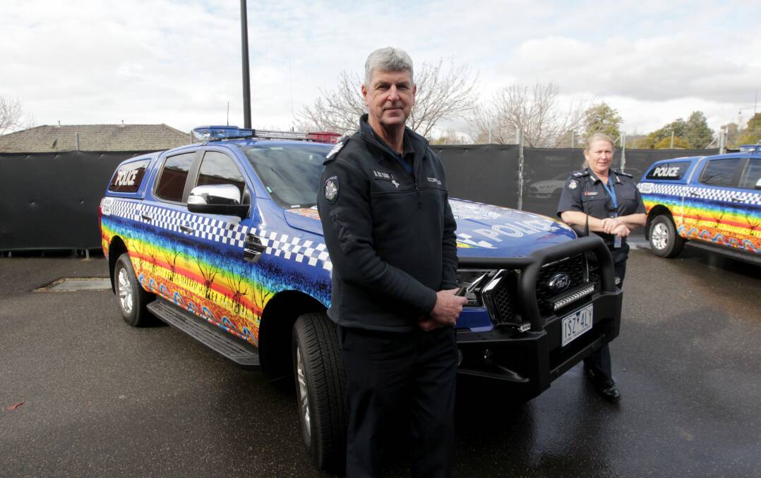 UNVEILED: Senior Sergeant Chris Parr and Superintendent Joy Arbuthnot with the cars, which are the first in Victoria to feature Aboriginal artworks. Picture: BLAIR THOMSON