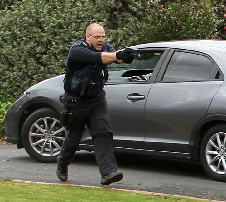 ARMED: Police used guns, batons and vehicles in a bid to stop the stolen car. Pictures: BLAIR THOMSON