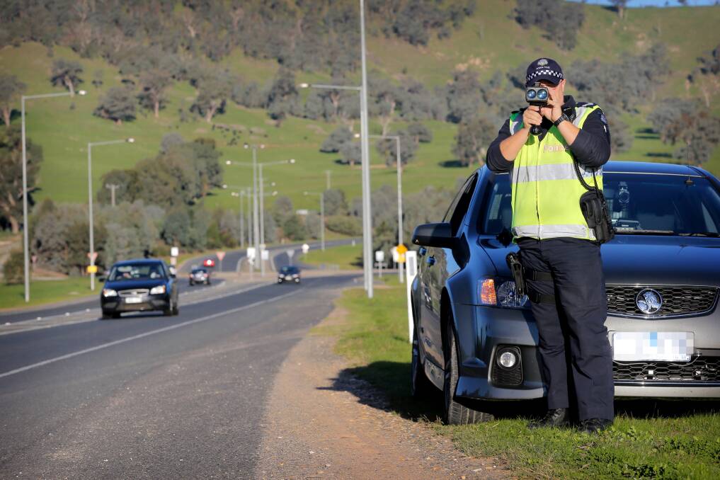 CHASE: A file photo of a policeman on the Bandiana Link Road. 