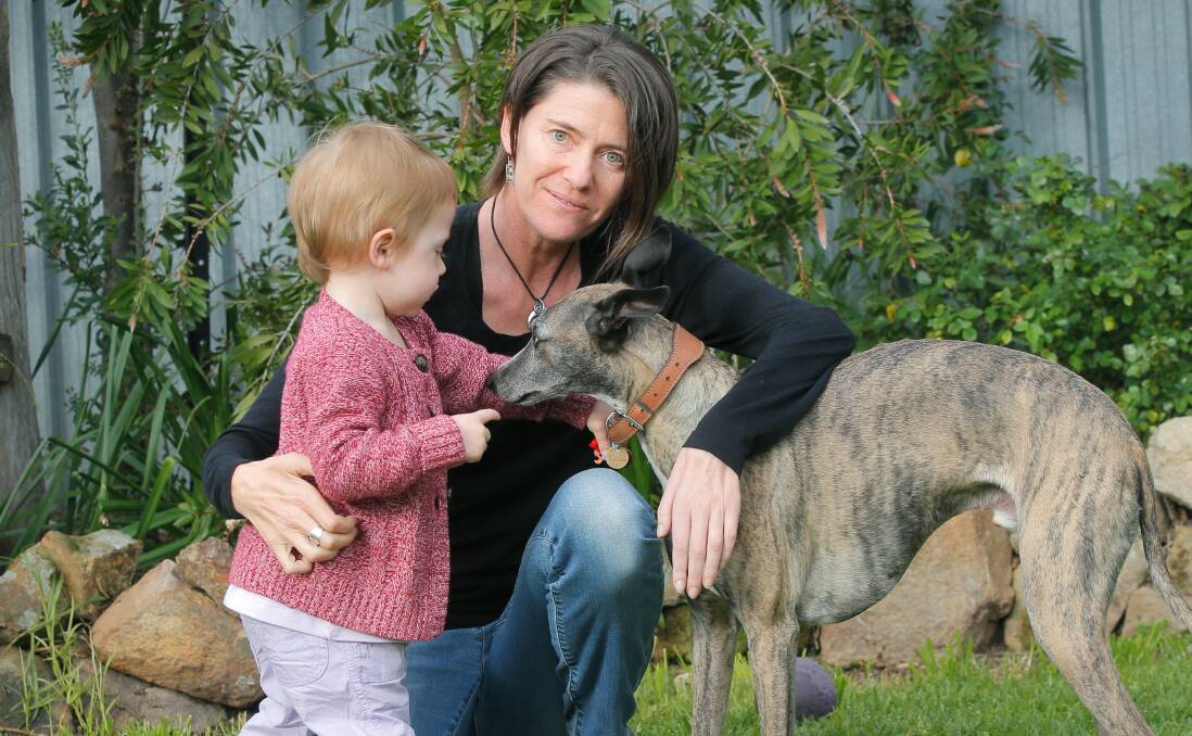 FIGHTING: Tonia Oswald-Sealy, pictured in 2014 with her daughter Jess and dog Kozzie in the backyard of their East Albury home. She spoke of the need to raise money to research motor neurone disease. 