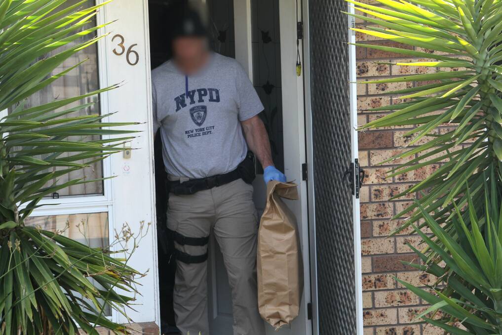 RAID: A Wodonga officer searches a property last month as part of an investigation into drug trafficking. 