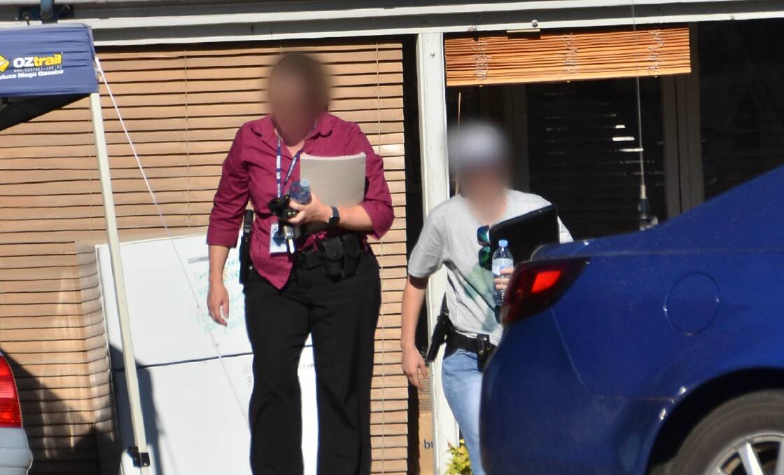CROP FOUND: Detectives outside shooting victim Justin Blake Smith's home in North Albury, which was found to have 47 cannabis plants growing underneath it. 