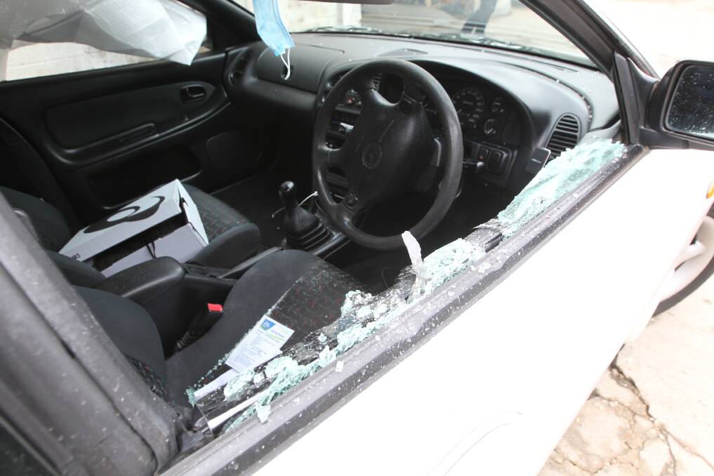 SMASHED: Police broke the window of the white Mazda to arrest the 30-year-old. Picture: BLAIR THOMSON