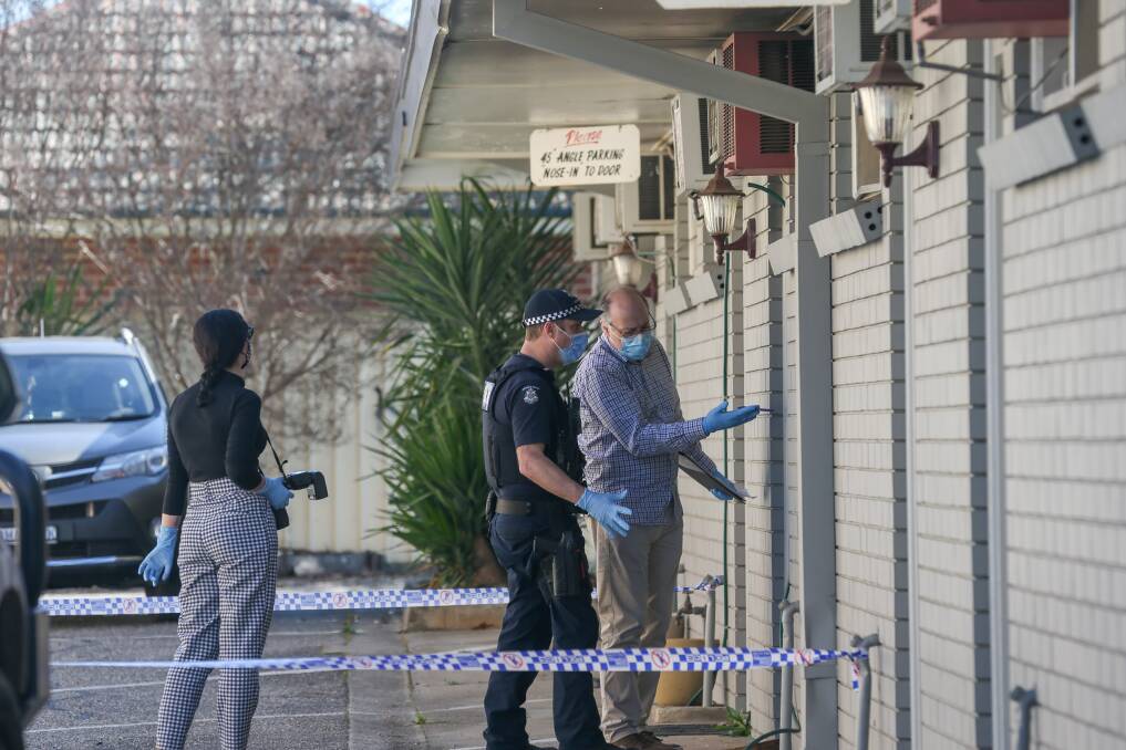 CRIME SCENE: Police examine the property on Monday. 