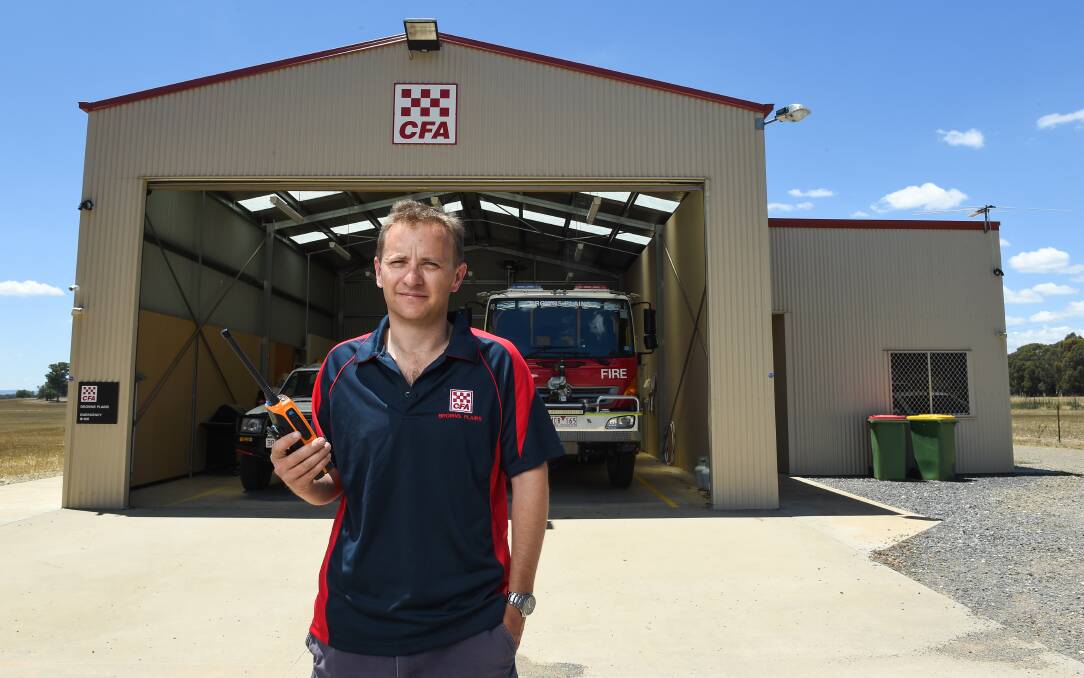BREAK-IN: Browns Plains CFA captain Matthew Partridge with a distinctive orange radio similar to the one stolen from the brigade's station during a break-and-enter last week. Picture: MARK JESSER