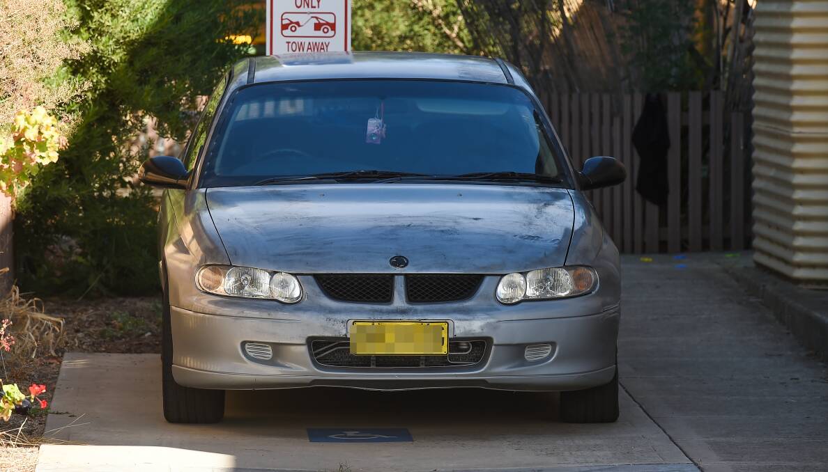 TOWED: Police also seized this silver Holden Commodore from outside the unit. The vehicle appeared to have a modified number plate attached to the front end. 