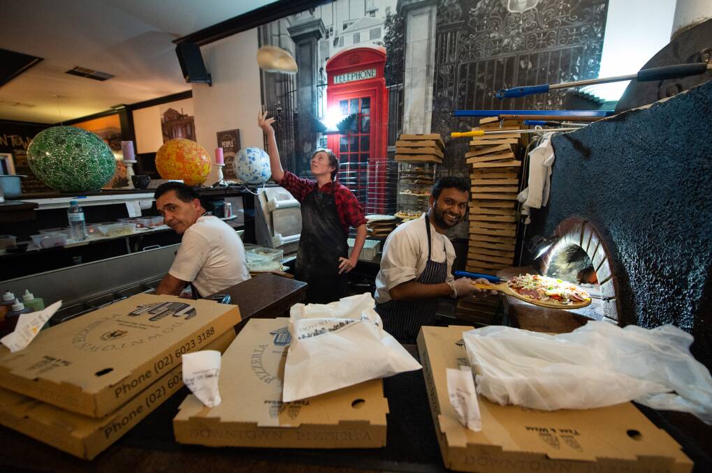 8:00pm Downtown Pizzeria continues to operate with a significantly reduced number of staff. Pictured: staff Pasqale Mercadante, Bailey James and Tanvir Azad. 