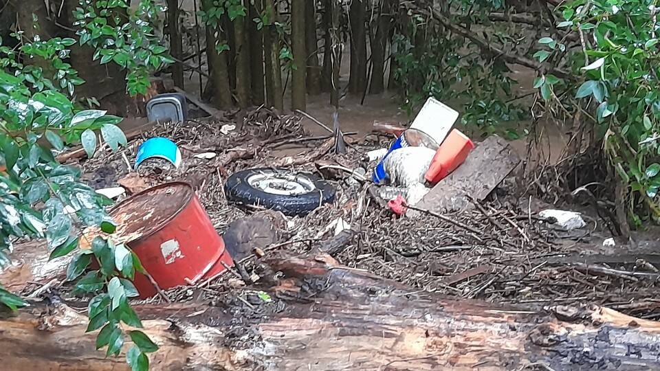 DEBRIS: Items including tyres and fuel drums which have washed into the creek. 