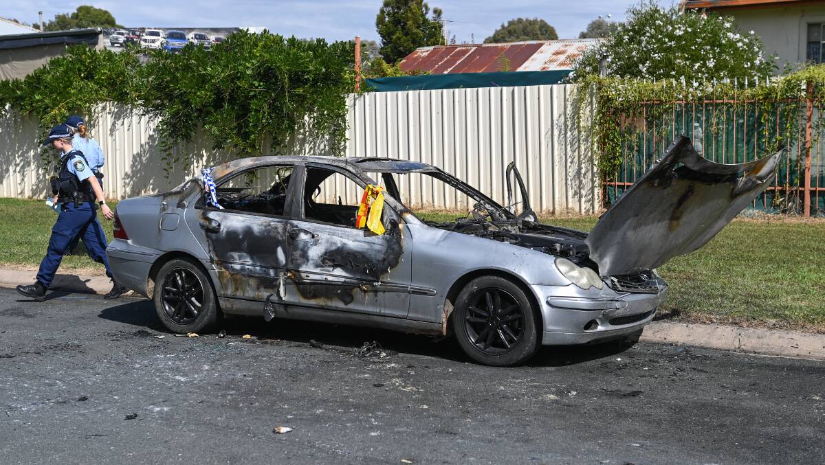 GUTTED: Police with a burnt out Mercedes in Lavington. Officers and firefighters have been called to four recent car fires in Springdale Heights, Lavington, Glenroy and Barnawartha. Picture: MARK JESSER