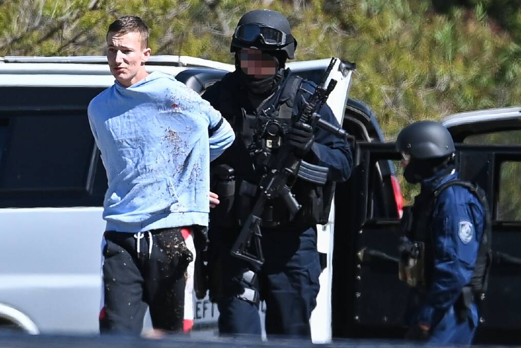 ARREST: Kyle Crighton is taken into custody by police in West Albury on Friday. He was later placed into hotel quarantine, which he allegedly fled on Thursday morning. 