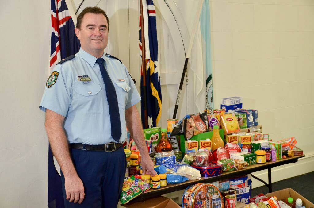 DONATION: Superintendent Evan Quarmby with some of the items donated to farmers in need. Picture: BLAIR THOMSON