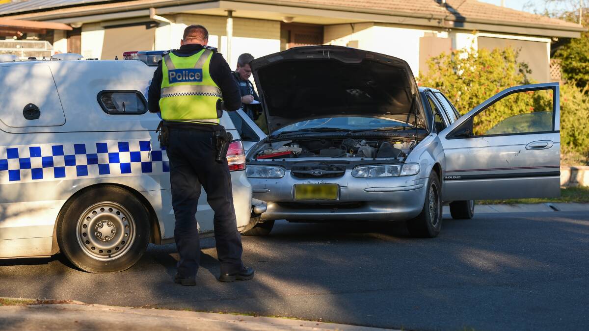 STRUCK: Police with the Ford Falcon and divisional van after they collided in Belgrade Avenue on Thursday. 
