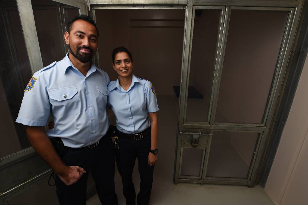 OPEN DOOR: Husband and wife pair Jaideep and Sugam, pictured at the Albury holding cells, have spoken of their work managing people in custody. They say it's good to see how the Australian system works. Picture: MARK JESSER