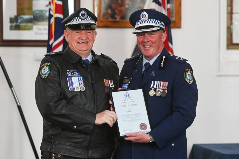 Sergeant Francis O'Brien received a unit citation for his work on the border closure during the pandemic from Superintendent Paul Smith. Picture by Mark Jesser