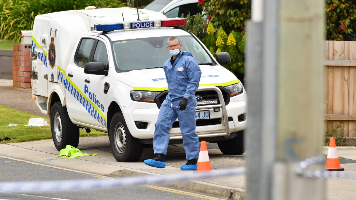 CRIME SCENE: A forensic officer outside the home where the shooting occurred. Picture: THE ADVOCATE