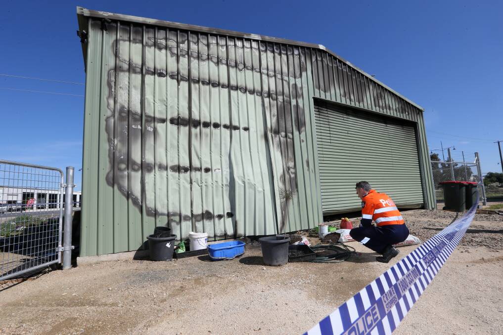 EXAMINATION: Wodonga Detective Sergeant Graeme Simpfendorfer examines damage to the structure and its contents on October 24 last year. 