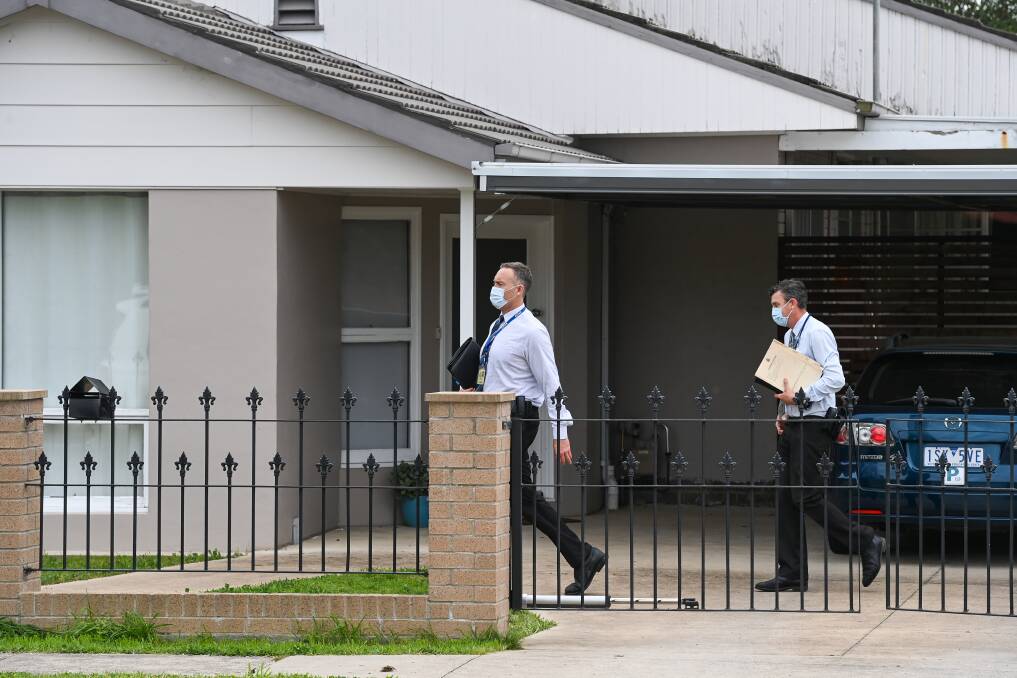 RAID: Police search a Lawrence Street home on Thursday. 