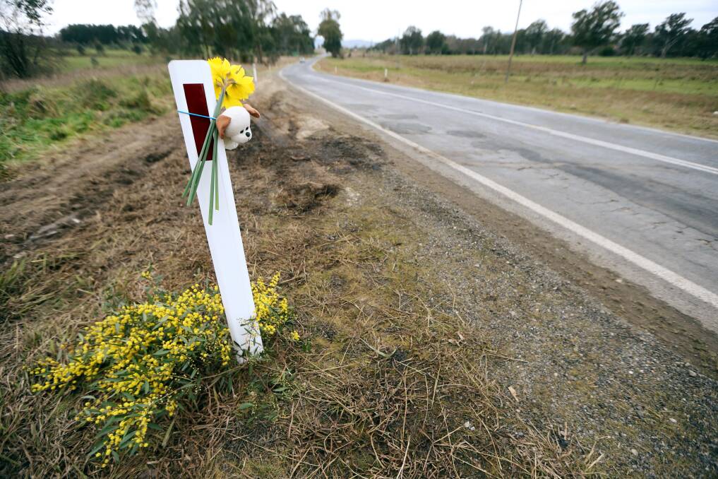 TRIBUTE: A toy and flowers left at the crash site a short time after the incident. 