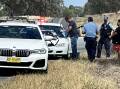Police search a car on the Riverina Highway at Bungowannah, about 16 kilometres outside of Albury, on Wednesday morning. Picture by @jacstanley7/Seven News