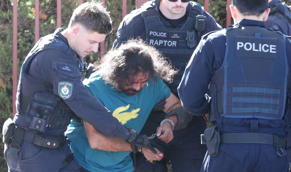 Police take a man into custody on Guinea Street in Albury after Monday's car chase. Picture by Blair Thomson