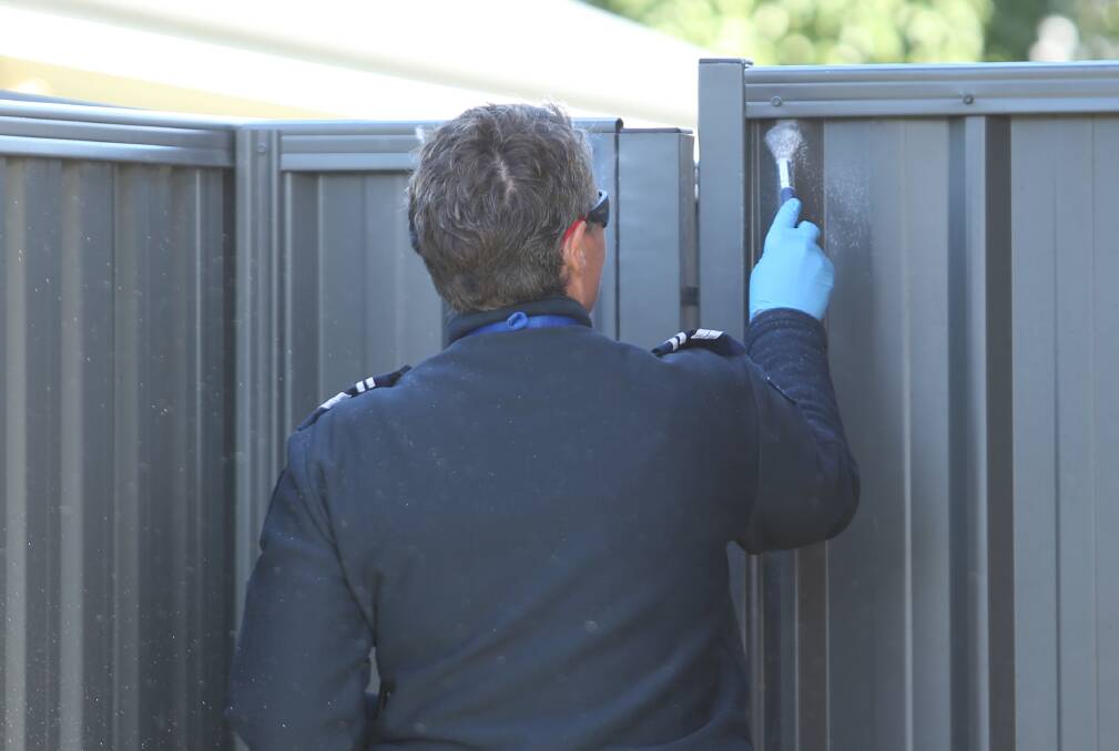 CRIME SCENE: Police dusted for prints at the Killara home following the aggravated burglary a few hours earlier. 
