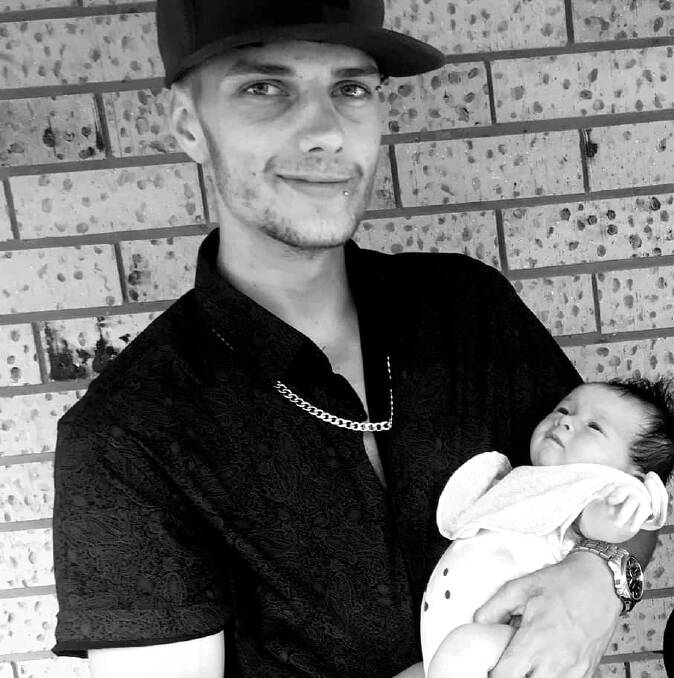 KILLED: Issac Smith, 19, with his newborn daughter. 