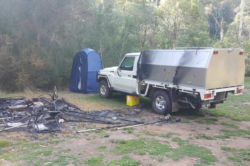 BURNT OUT: A photograph provided to the ABC shows Mr Hill's burnt vehicle next to the remnants of the pair's campsite. They haven't been seen for six months. 