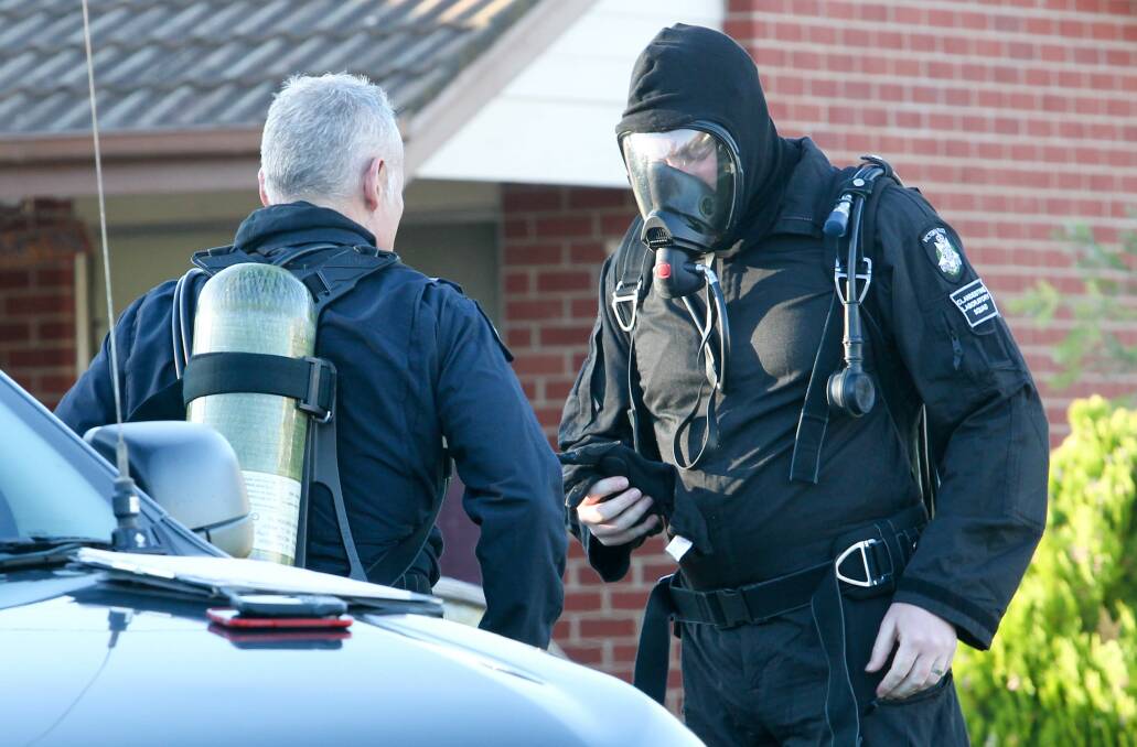 SEARCH: Officers from the Clandestine Laboratory Squad prepare to search a home in Wodonga in May 2017. The house was contaminated with methamphetamine residue. 